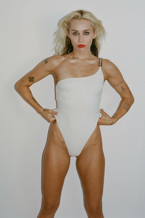 Miley Cyrus wears a bikini and spreads legs