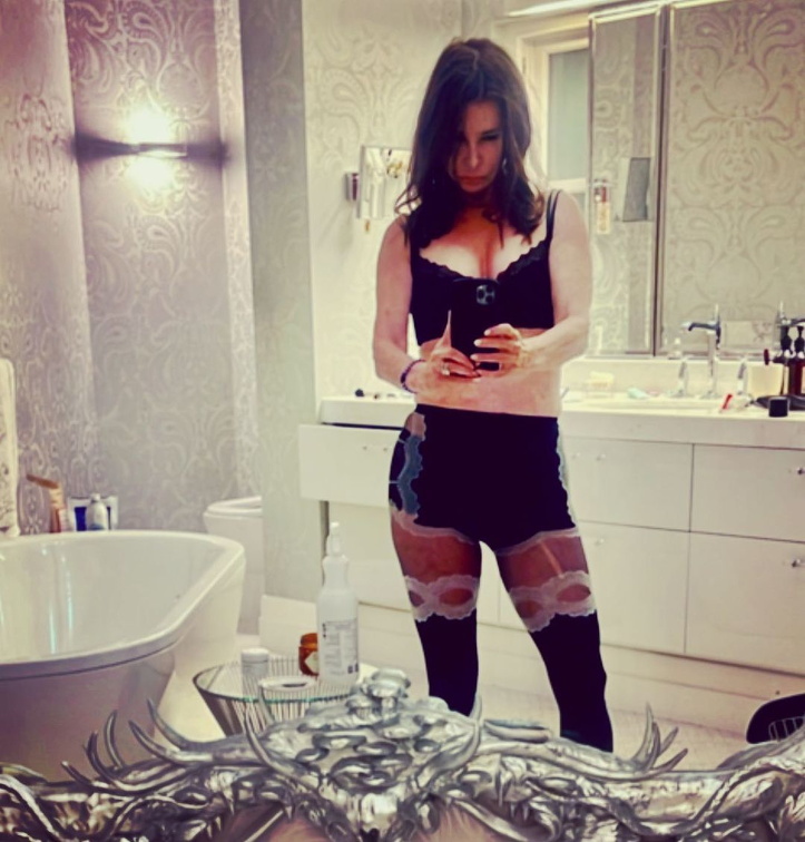Jane Badler takes a selfie in bathroom wearing sexy clothes