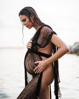 Odette Yustman shows her pregnant belly in see through clothing