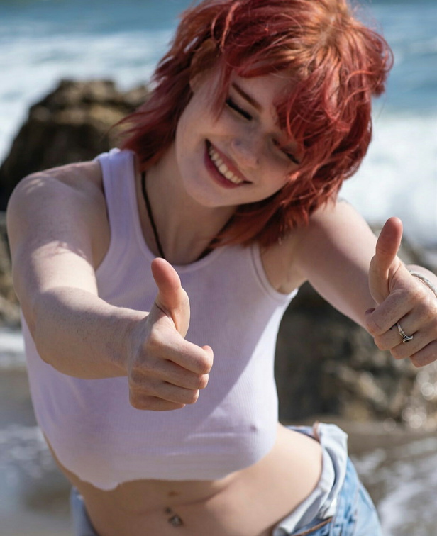 Hannah McCloud gives a thumbs up while exposing her nipples